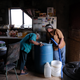 Nancy Bitsue, an elderly member of the Navajo Nation, receives her monthly water delivery in the town of Thoreau, New Mexico.